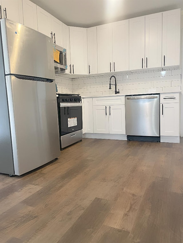 kitchen featuring white cabinets, dark hardwood / wood-style flooring, sink, and appliances with stainless steel finishes