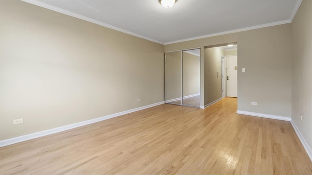 unfurnished bedroom featuring a closet, ornamental molding, and light wood-type flooring