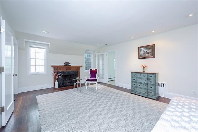 sitting room featuring radiator heating unit, baseboard heating, and dark wood-type flooring