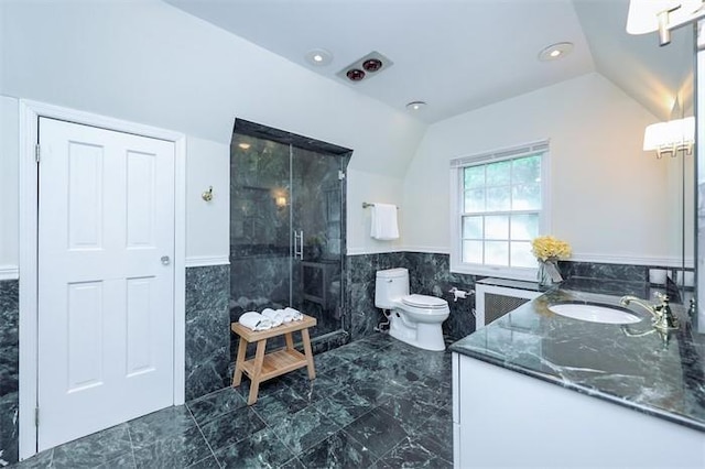 bathroom featuring radiator, lofted ceiling, tiled shower, toilet, and tile walls