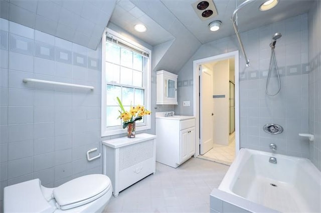 full bathroom with vanity, toilet, tile walls, and tiled shower / bath combo