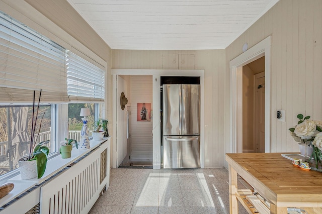 hall with radiator and wooden walls