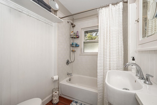 bathroom with shower / tub combo, hardwood / wood-style flooring, and sink