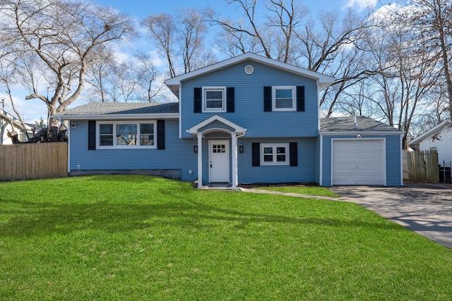 view of front of property with a garage and a front lawn