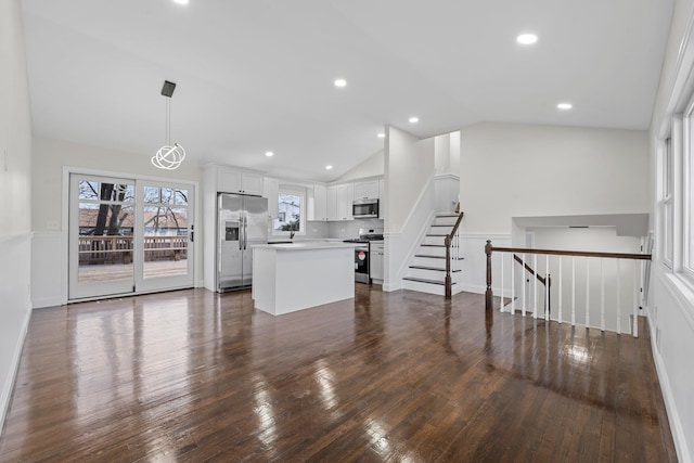 unfurnished living room with dark wood-type flooring and vaulted ceiling