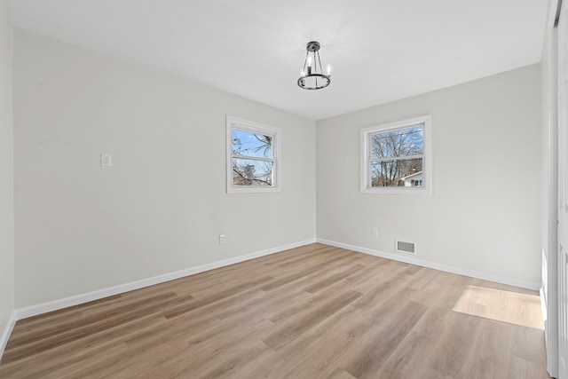 unfurnished dining area with light hardwood / wood-style floors and a chandelier