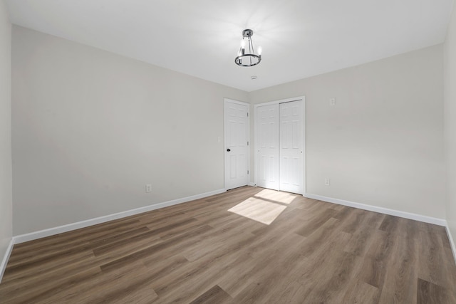 interior space featuring dark wood-type flooring and a notable chandelier