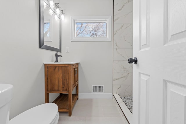 bathroom with a shower, vanity, and toilet