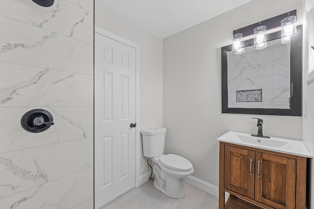 bathroom with tile patterned flooring, vanity, and toilet