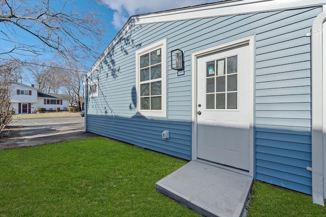 view of exterior entry featuring a yard