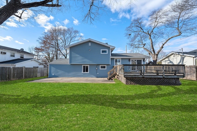 rear view of house featuring a lawn, a patio area, and a wooden deck