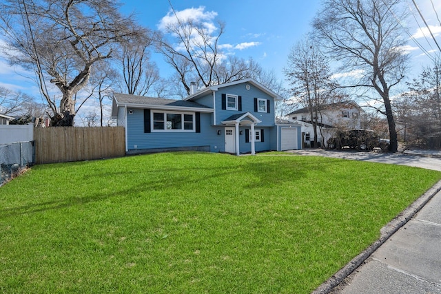 view of front of property with a front yard and a garage