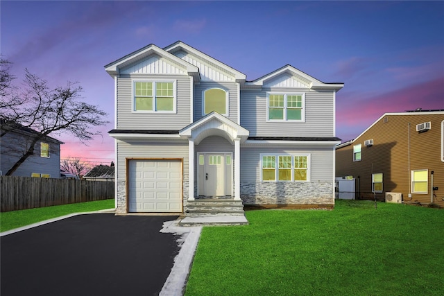 craftsman house featuring a lawn, ac unit, and a garage