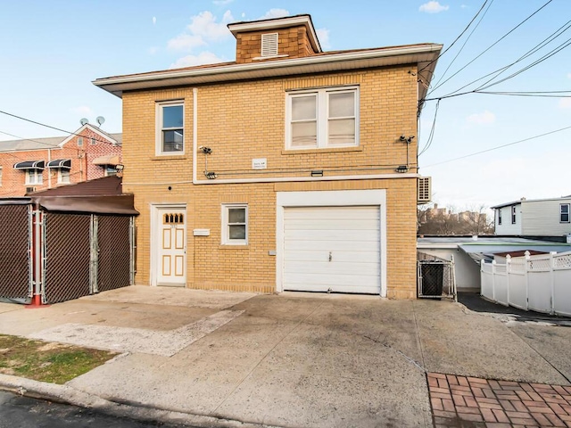 rear view of property featuring a garage