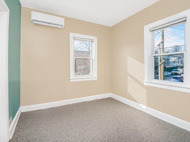 carpeted spare room featuring an AC wall unit