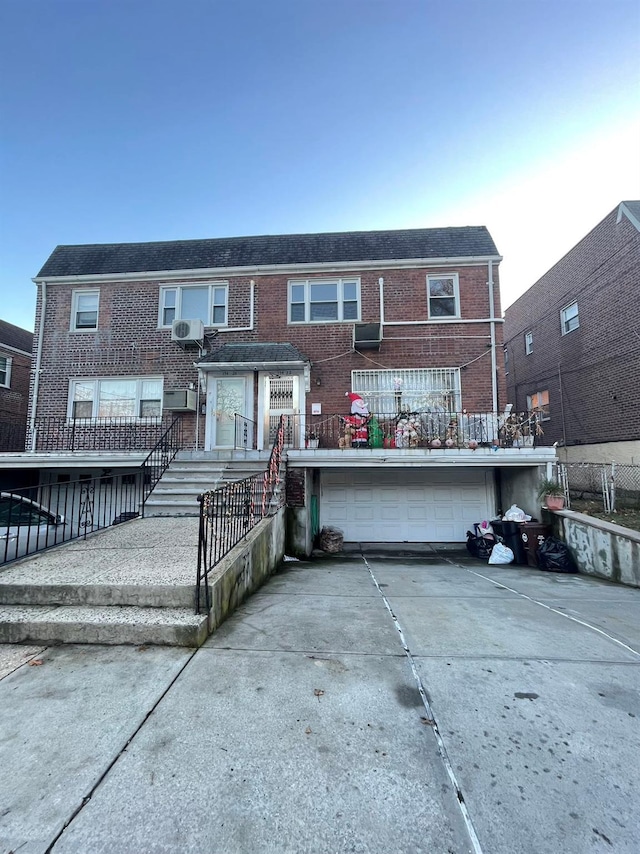 rear view of property featuring a garage