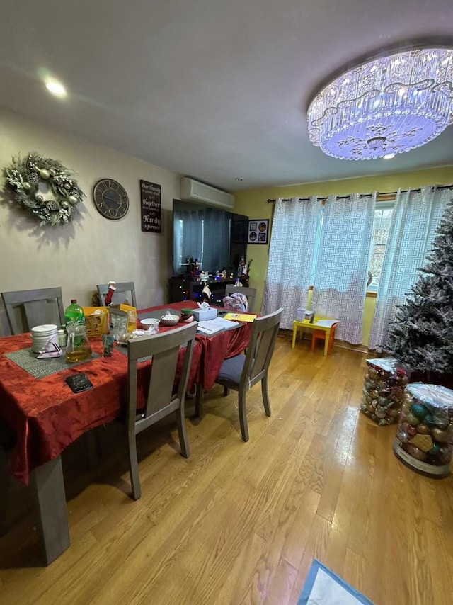 dining room with hardwood / wood-style flooring and an AC wall unit