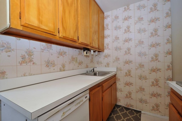 kitchen featuring white dishwasher, tile patterned flooring, and sink