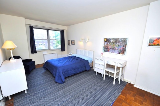 bedroom with dark parquet flooring