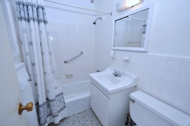 full bathroom featuring tile walls, vanity, toilet, shower / bath combo, and tile patterned floors