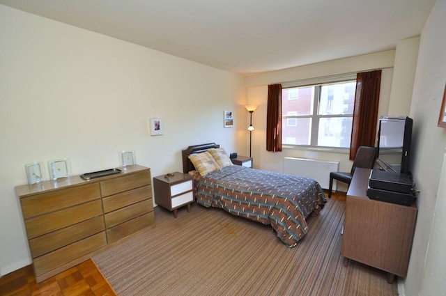 bedroom with dark parquet flooring