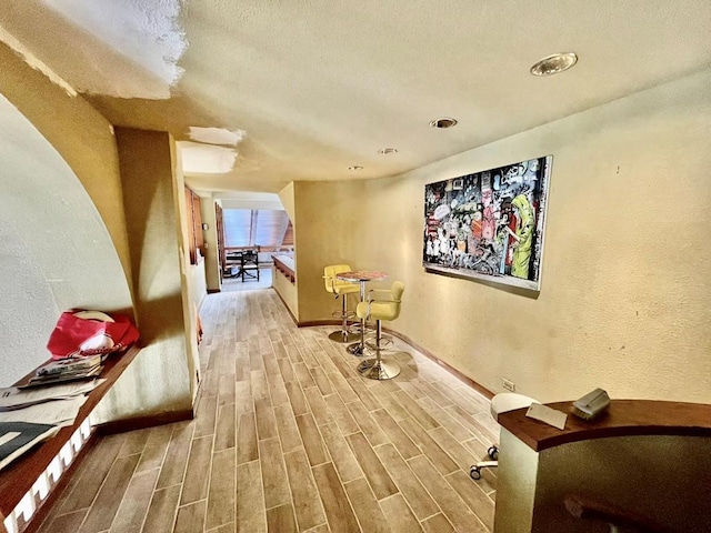 6 Hidden Pond, Muttontown, NY 11545 - hall with wood finished floors, a textured wall, baseboards, and recessed lighting