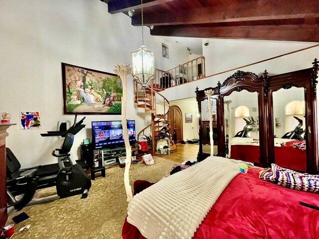 6 Hidden Pond, Muttontown, NY 11545 - carpeted bedroom with beam ceiling, a chandelier, and high vaulted ceiling