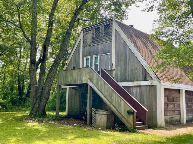 6 Hidden Pond, Muttontown, NY 11545 - rear view of house with roof with shingles, stairs, a lawn, and a detached garage