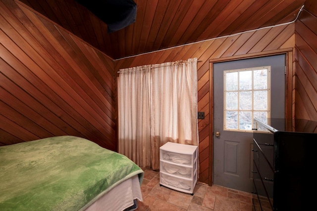 bedroom featuring wood walls