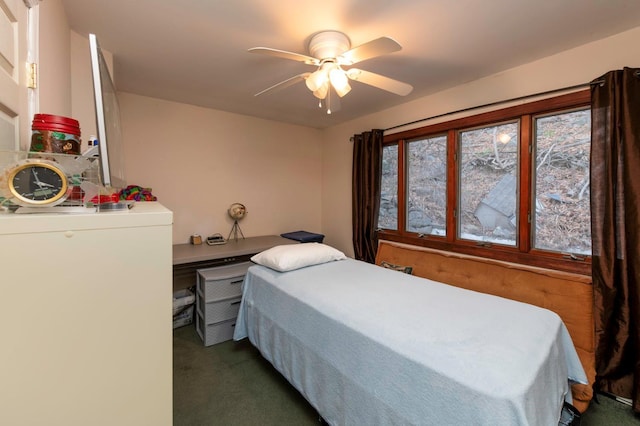 bedroom featuring dark colored carpet and ceiling fan