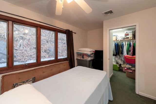 carpeted bedroom featuring ceiling fan and a closet