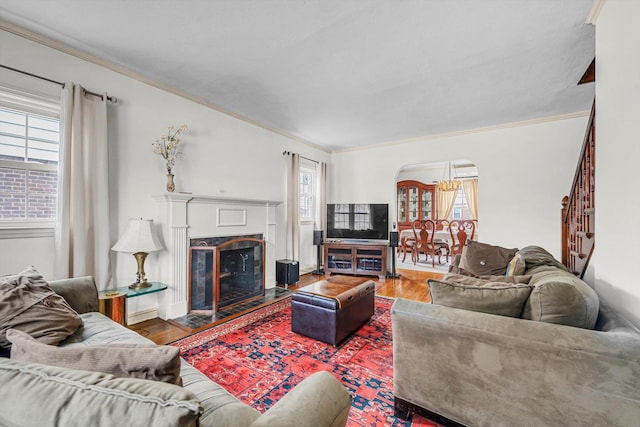 living room featuring wood-type flooring and ornamental molding