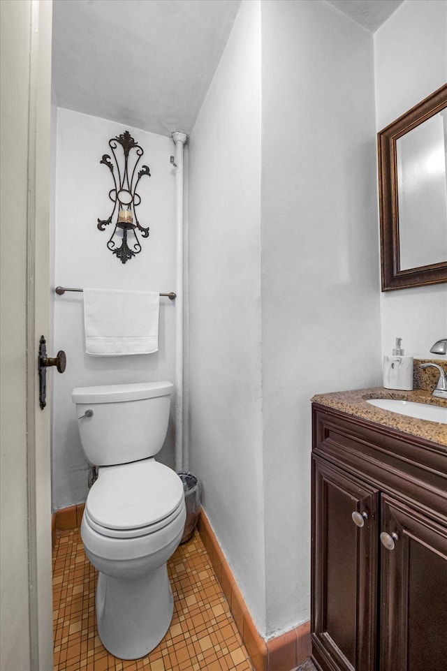 bathroom featuring tile patterned flooring, vanity, and toilet