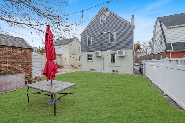 rear view of house featuring a lawn