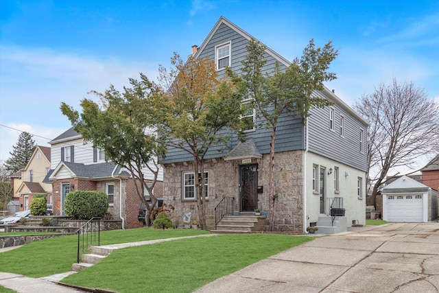 view of front property with a garage, a front lawn, and an outdoor structure