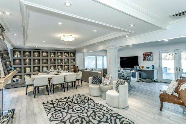 living room featuring light wood-type flooring, crown molding, and plenty of natural light