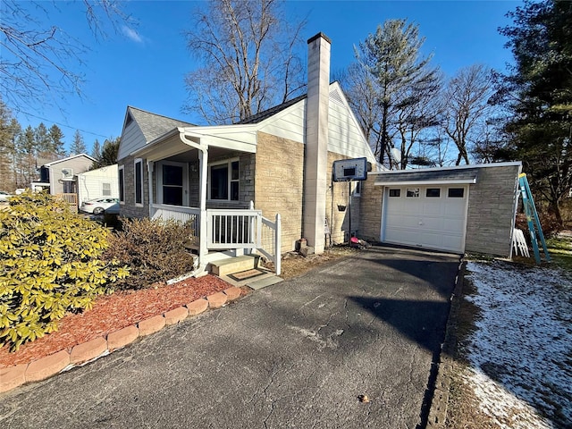 view of side of home with a porch and a garage