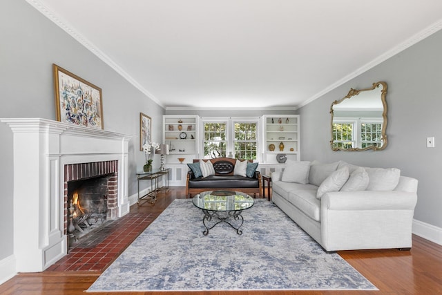 living room with a brick fireplace, dark hardwood / wood-style flooring, and crown molding