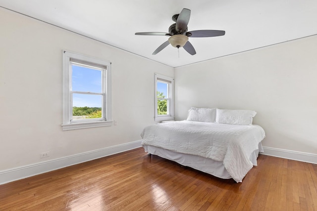 bedroom with ceiling fan and hardwood / wood-style flooring