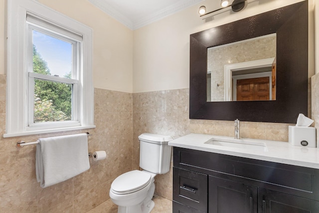 bathroom featuring toilet, tile patterned flooring, tile walls, ornamental molding, and vanity