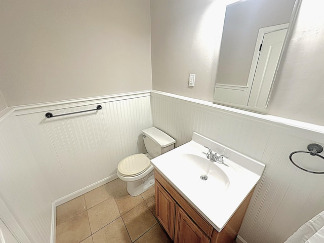 bathroom featuring tile patterned flooring, vanity, and toilet