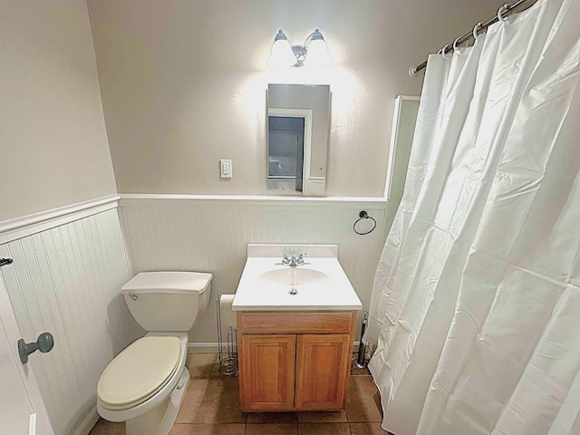 bathroom featuring tile patterned flooring, vanity, and toilet