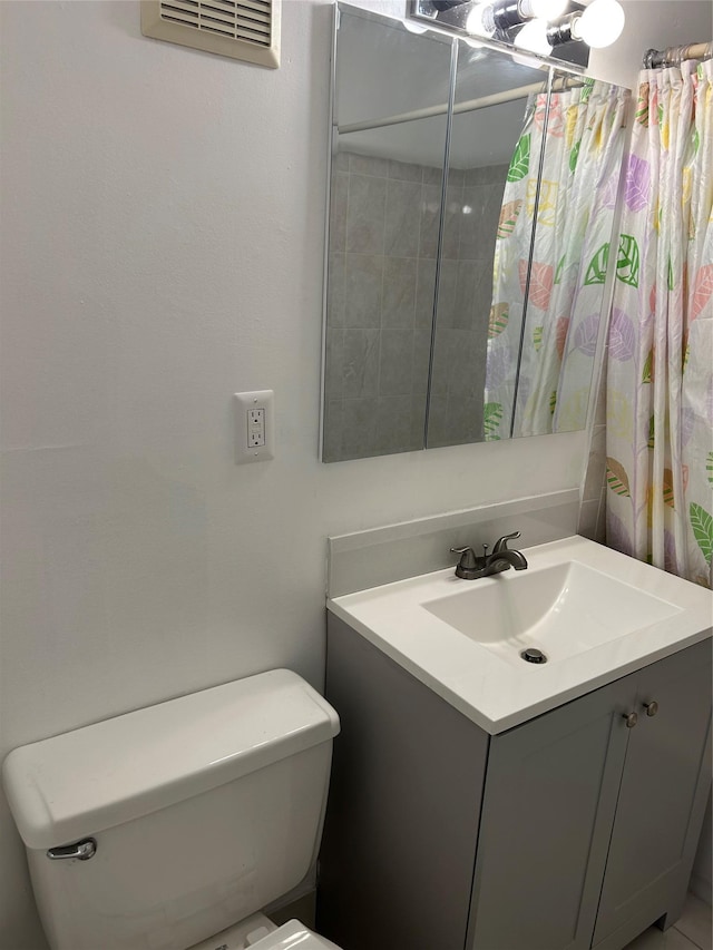 bathroom with toilet and vanity