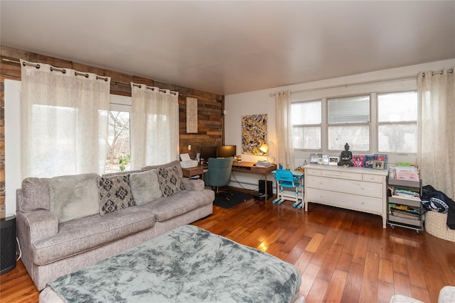 living room featuring dark hardwood / wood-style floors and wooden walls