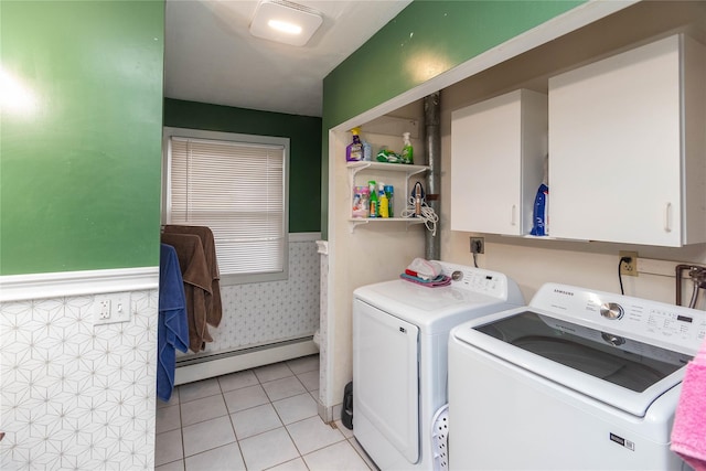 washroom featuring light tile patterned floors, a baseboard radiator, and washer and clothes dryer