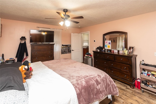 bedroom featuring ceiling fan, a textured ceiling, and light wood-type flooring