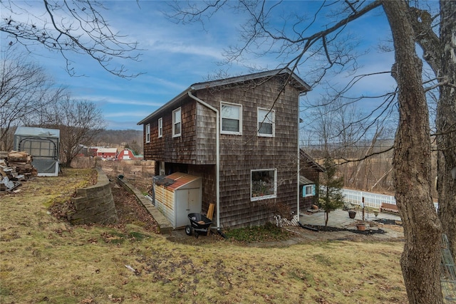 view of side of home featuring a yard