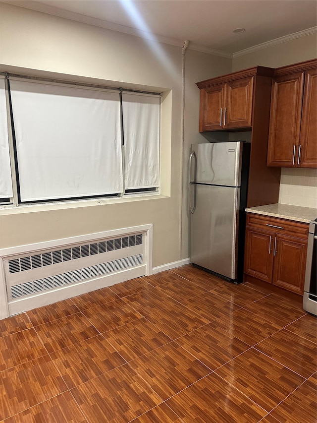 kitchen featuring freestanding refrigerator, decorative backsplash, radiator heating unit, dark wood finished floors, and crown molding