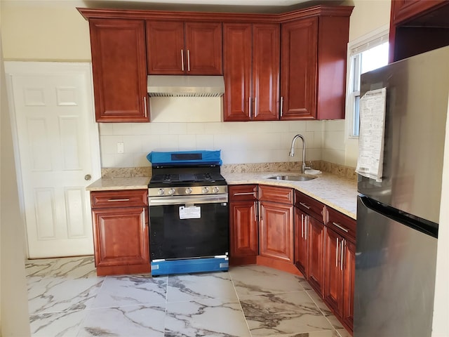 kitchen featuring appliances with stainless steel finishes, extractor fan, light stone countertops, and sink