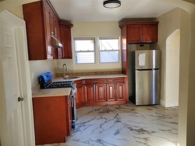 kitchen featuring appliances with stainless steel finishes, tasteful backsplash, and sink